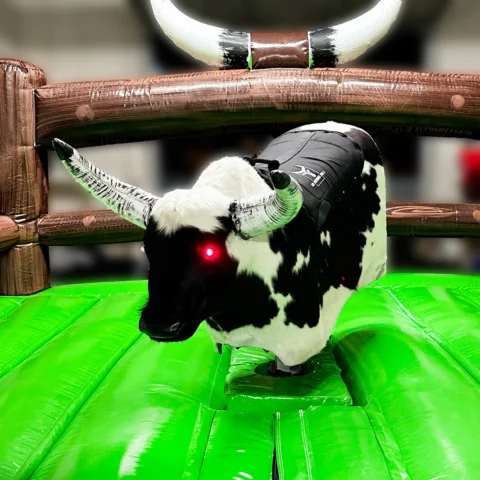 A mechanical bull in a showroom with glowing red eyes.